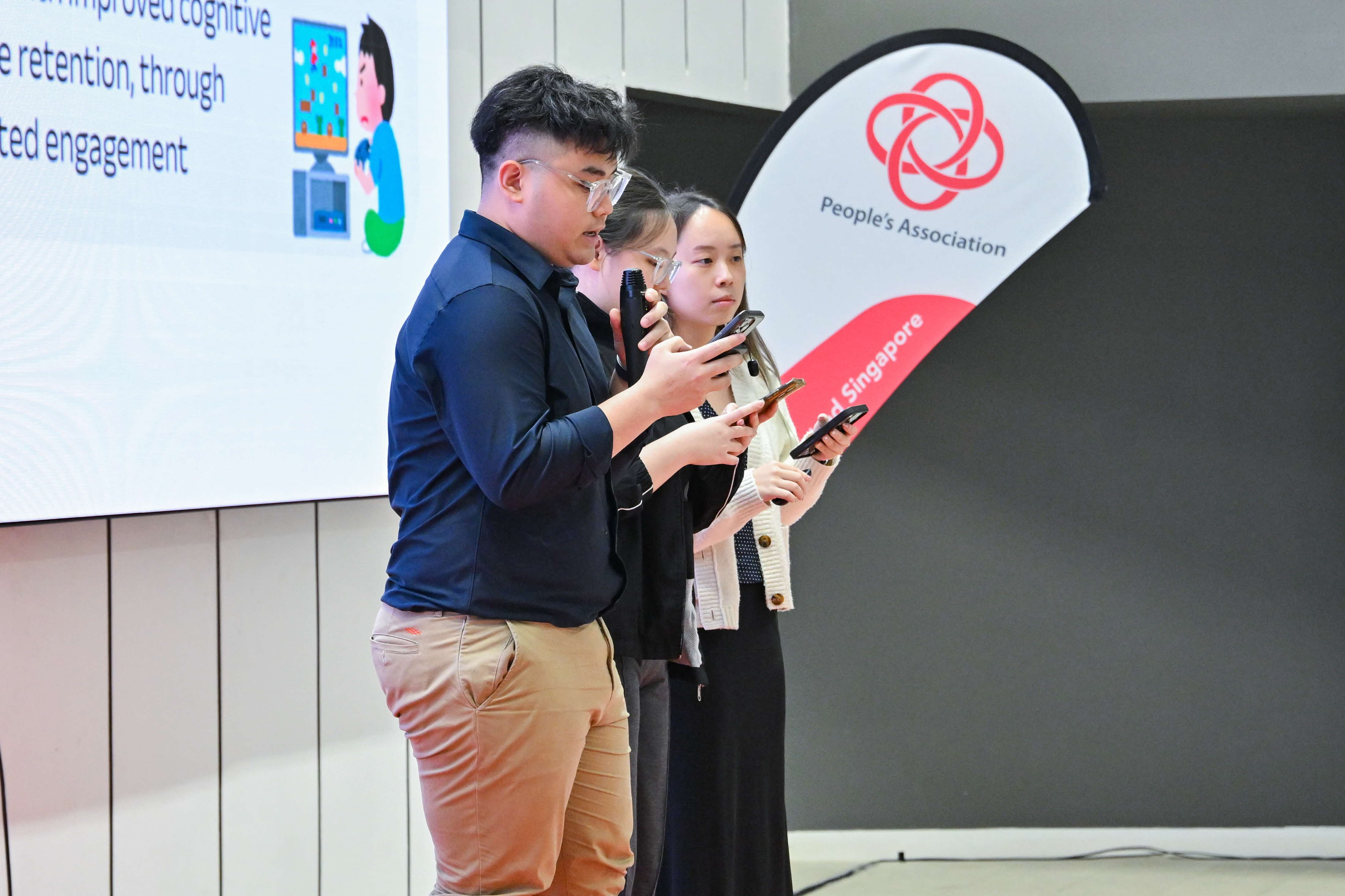 Three students explaining to the audience and panel